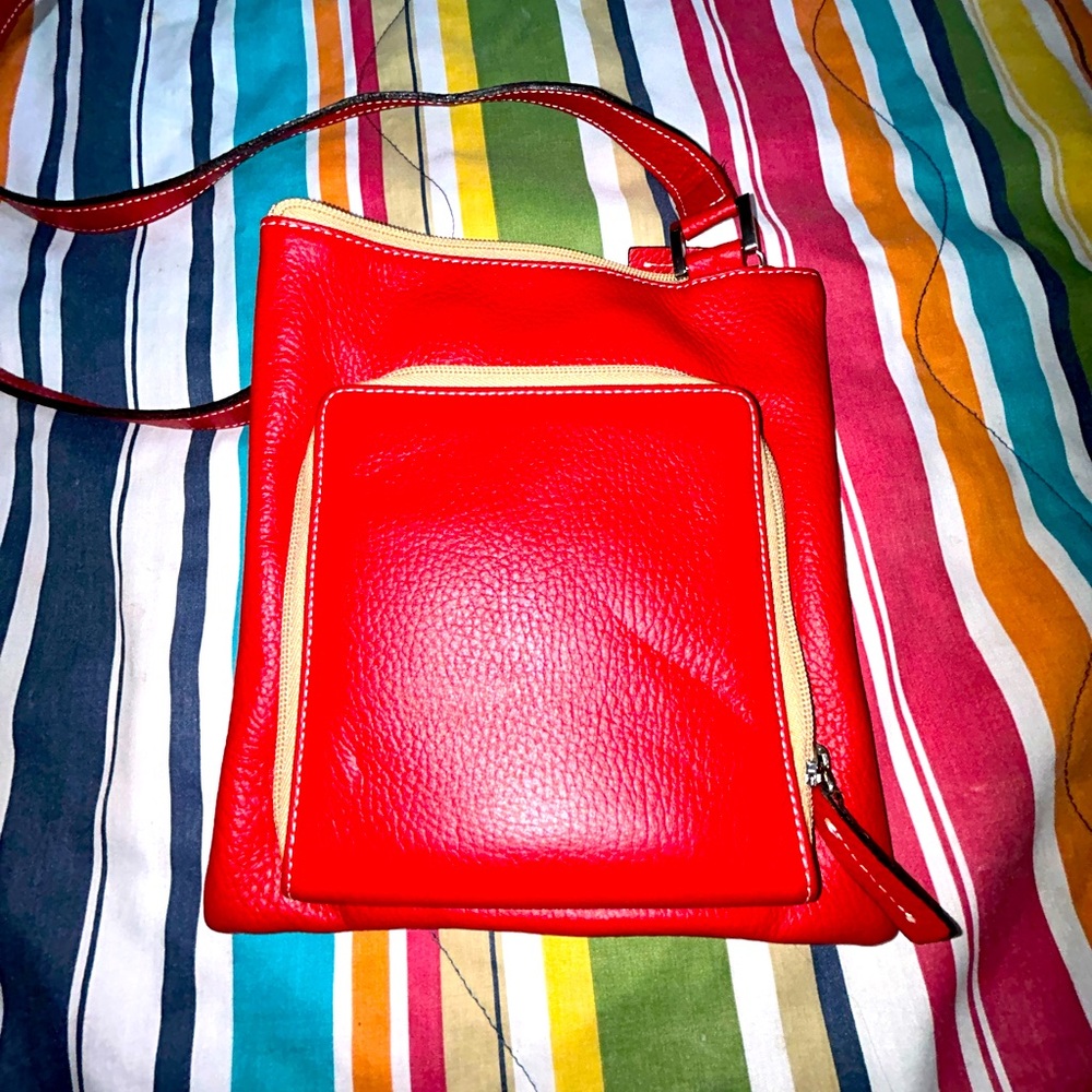 Red and tan handcrafted leather purse by Raika.
